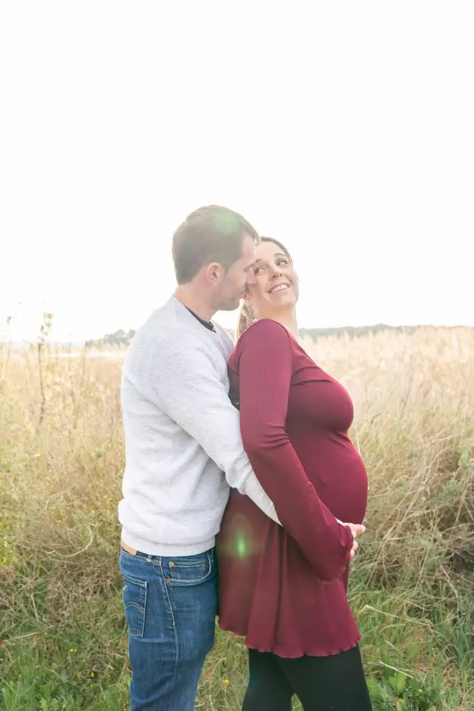 a man and woman standing in a field