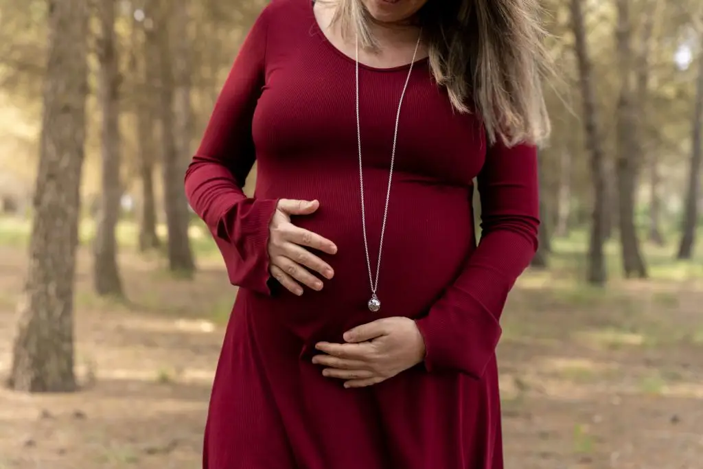 a pregnant woman in a red dress